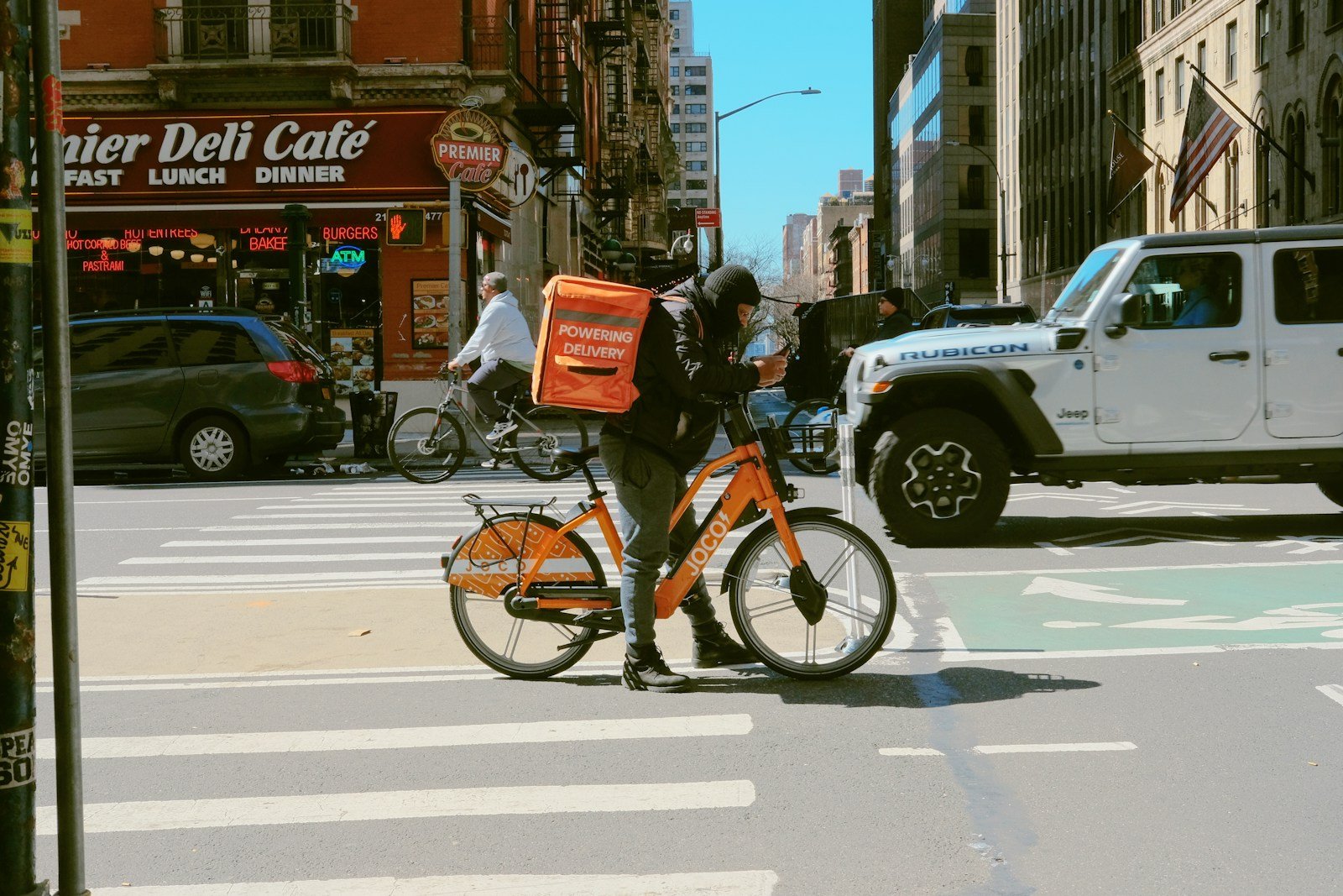 a person on a bike with a box on the back of it