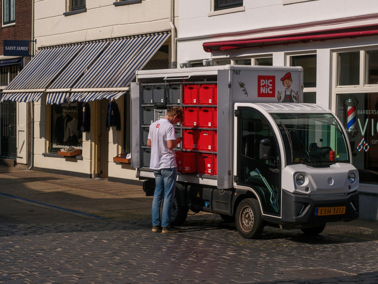 A man standing next to a small truck